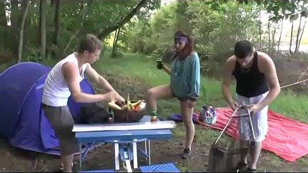 A girl fucked hard by two guys in a camping
