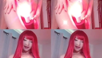 Cosplaying as an anime girl by wearing a red wig and a sexy blue bra