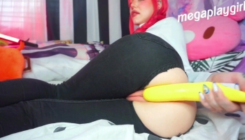 Clown girl is sucking on a yellow toy and she can’t help but fuck herself with it
