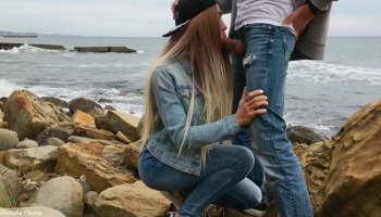 Kinky babe in a snapback sucks on a guy’s cock in a scenic spot on the beach
