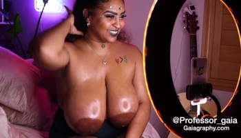 Oversized and oiled up boobies spotlighted in a hot pornographic solo scene
